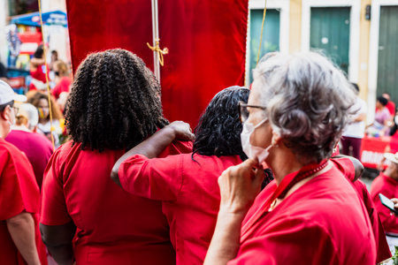 Salvador, Bahia, Brazil - December 04, 2022: Devotees of Santa Barbara dressed in red during mass at Largo do Pelourinho in the city of Salvador.のeditorial素材
