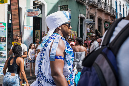 Salvador, Bahia, Brazil - February 11, 2018: Members of the traditional carnival block Filhos de Gandy parade in the streets of Salvador, Bahia during the 2018 carnival.のeditorial素材