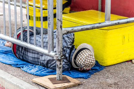 Salvador, Bahia, Brazil - February 09, 2018: Street vendor sleeping on the street after Carnival night in the city of Salvador in Bahia.のeditorial素材