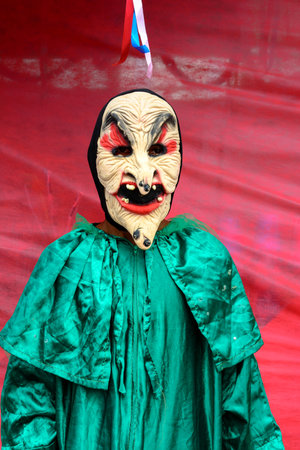 Maragogipe, Bahia, Brazil - February 27, 2017: A person dressed in a horror costume against a red background at the Maragojipe Carnival, Bahia.のeditorial素材