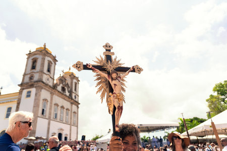 Salvador, Bahia, Brazil - January 06, 2023: Catholics touching the image of Jesus Christ during mass...