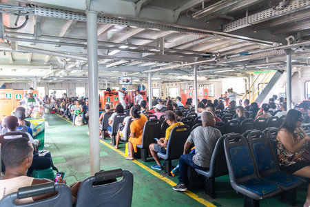 Itaparica, Bahia, Brazil - January 24, 2023: Many passengers sitting inside the Ferry-Boat in...
