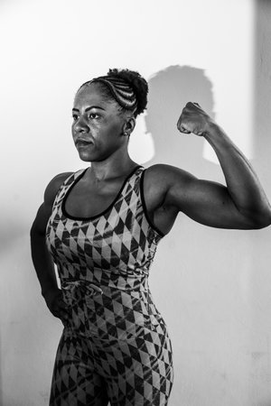 Beautiful woman showing upper muscles. isolated on white background.の写真素材