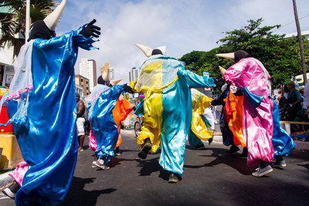 Salvador, Bahia, Brazil - February 11, 2023: Group of masked people are dancing in the street during the pre-carnival Fuzue parade in Salvador, Bahia.のeditorial素材
