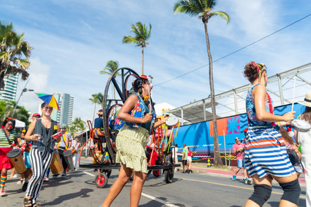 Salvador, Bahia, Brazil - February 11, 2023: Circus performers dance, sing and play percussion instruments during the pre-Carnival Fuzue parade in the city of Salvador, Bahia.のeditorial素材