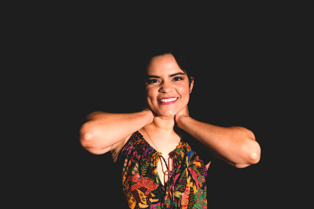 Studio portrait of beautiful and confident woman. Isolated on black background.の写真素材