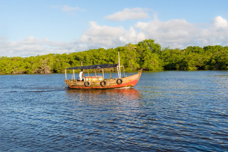 Valenca, Bahia, Brazil - September 09, 2022: Boat sailing on the Una river in the late afternoon in the city of Valenca, Bahia.のeditorial素材