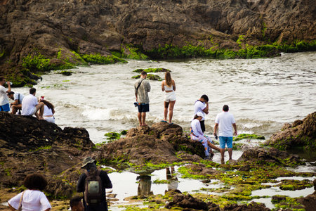 Salvador, Bahia, Brazil - February 02, 2023: Many people are on the rocks of Rio Vermelho beach offering gifts to Yemanja, in Salvador, Bahia.のeditorial素材