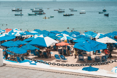 Salvador, Bahia, Brazil - January 14, 2022: Several tourist people are sheltering from the strong sun on Porto da Barra beach in Salvador, Bahia.のeditorial素材