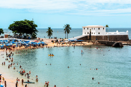 Salvador, Bahia, Brazil - January 14, 2022: High view of Santa Maria fort and tourist people having fun at Porto da Barra beach in Salvador, Bahia.のeditorial素材