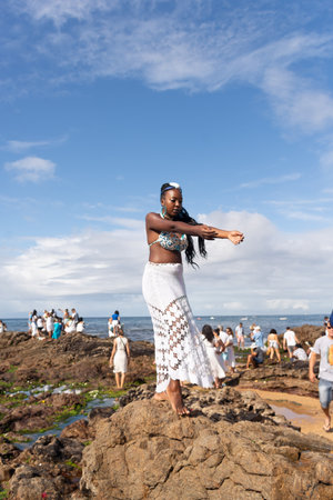 Salvador, Bahia, Brazil - February 02, 2023: Candomble people are on the rocks of Rio Vermelho beach, offering gifts to Yemanja. Salvador, Bahia.のeditorial素材