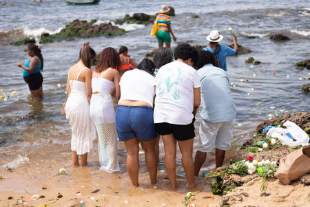 Salvador, Bahia, Brazil - February 02, 2023: Candomble people enter the waters of Rio Vermelho beach to offer gifts to Yemanja, in Salvador, Bahia.のeditorial素材