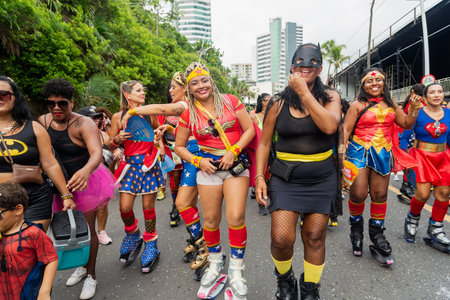 Salvador, Bahia, Brazil - February 11, 2023: Group of women dressed as superheroes joyfully parade in the pre-carnival Fuzue, in Salvador, Bahia.のeditorial素材