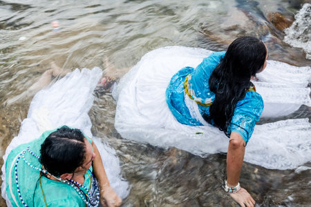 Salvador, Bahia, Brazil - February 02, 2017: Two faithful Candomble women bathe in the sea during the festival in honor of Iemanja. Salvador, Bahia.のeditorial素材