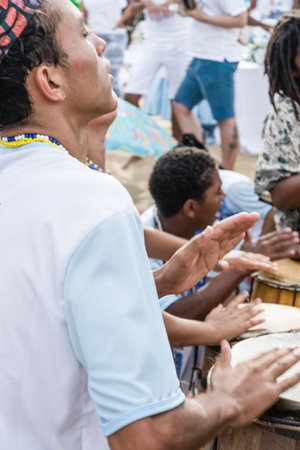 Salvador, Bahia, Brazil - February 02, 2017: Candomble fans play percussion during the Iemanja festival in Salvador, Bahia.のeditorial素材