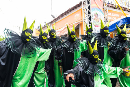 Maragogipe, Bahia, Brazil - February 20, 2023: Group of people dressed in Maragogipe grimaces pose for a photo at a carnival in Bahia, Brazil.のeditorial素材