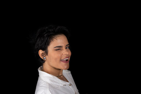 Close-up portrait of a beautiful woman wearing a white outfit. Isolated on black background.の写真素材