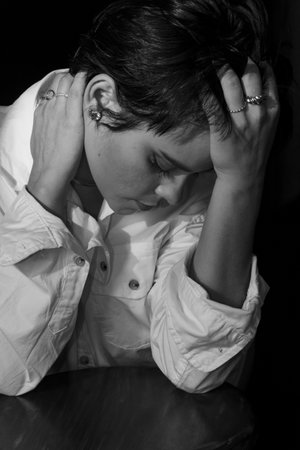 Black and white portrait of beautiful woman wearing white outfit. Isolated on black background.の写真素材