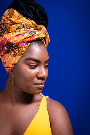 Beautiful young woman in vertical portrait against blue background.の写真素材