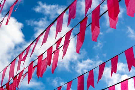 Decoration colorful flags. Against blue sky.の写真素材