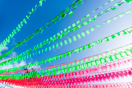 Decoration colorful flags. Against blue sky.の写真素材