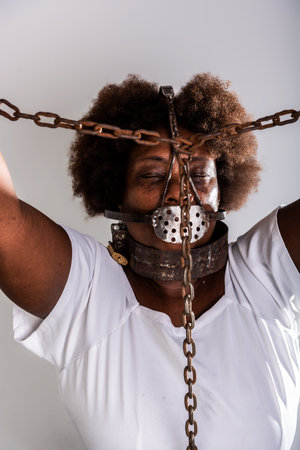 Portrait of a black woman in chains, representing the slave Anastacia. Slavery in Brazil.の写真素材