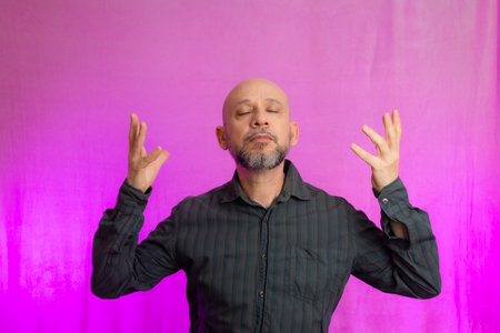 Portrait of serious man, 50 years old, with beard and bald head making hand signals. Isolated on...