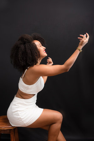 Beautiful young woman, funny and beautiful, making various gestures with hands, mouth and eyes. Isolated on light gray background.の写真素材