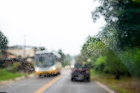 View of traffic, cars and lights from inside a car. rainy dayの写真素材