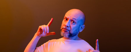 Happy bald bearded man making funny hand gestures. Concept of strength, achievement and success....