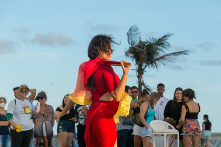 Salvador, Bahia, Brazil - October 22, 2022: Street artist doing a dance performance for many people at Farol da Barra, in Salvador, Bahia.のeditorial素材