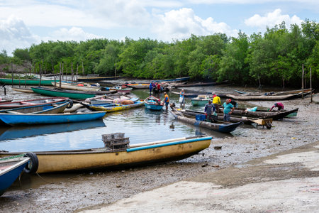 Santo Amaro, Bahia, Brazil - July 24, 2022: Fishermen are seen preparing their canoes for fishing on...