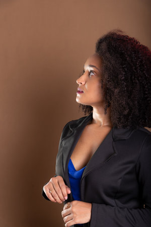 Portrait of young, beautiful businesswoman. Success concept. Isolated on brown background.の写真素材