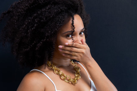 Beautiful young woman, funny and beautiful, making various gestures with hands, mouth and eyes. Isolated on light gray background.の写真素材