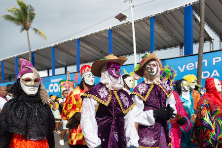 Salvador, Bahia, Brazil - February 11, 2023: Masked and costumed Venice-style group parade in the...