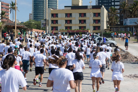 Salvador, Bahia, Brazil - August 23, 2015: Hundreds of people are seen, back to back running at the start of the marathon of colors in Salvador, Brazil.のeditorial素材
