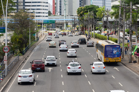 Salvador, Bahia, Brazil - August 11, 2023: Many cars, motorcycles and buses occupying the lanes of Avenida Tancredo Neves in the commercial center of the city of Salvador, Bahia,のeditorial素材