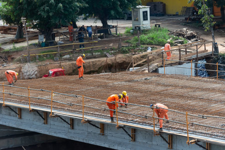 Salvador, Bahia, Brazil - August 11, 2023: Top view of a construction site with several workers doing work on Avenida Tancredo Neves in Salvador, Bahia,のeditorial素材