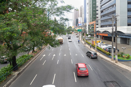 Salvador, Bahia, Brazil - August 11, 2023: Cars are seen traveling on Avenida Tancredo Neves, the commercial center of the city of Salvador, Bahia.のeditorial素材