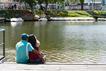 Salvador, Bahia, Brazil - January 04, 2015: The couple of lovers is seen sitting on the pier of Dique do Tororo looking at the lake. City of Salvador in Bahia.のeditorial素材