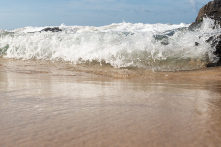 Sea water in the form of waves hitting the rocks on the beach. Free and healthy nature.の写真素材