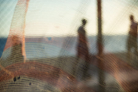 Silhouette and figure of pedestrians walking along the edge of a beach in the late afternoon. Abstract photography concept.の写真素材