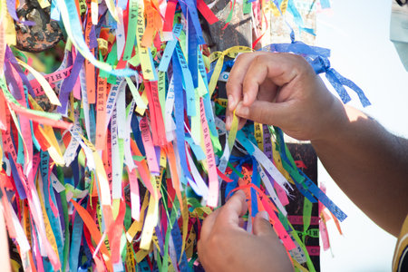 Salvador, Bahia, Brazil - January 07, 2022: Catholics are seen tying ribbons on the railing of the...