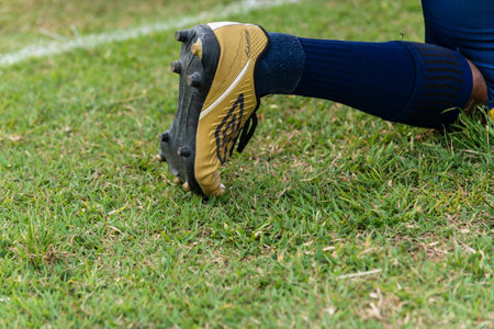 Camacari, Bahia, Brazil - September 30, 2023: A yellow Umbro football boot on the foot of a player at the Armando Oliveira stadium in Camacari, Bahia.のeditorial素材