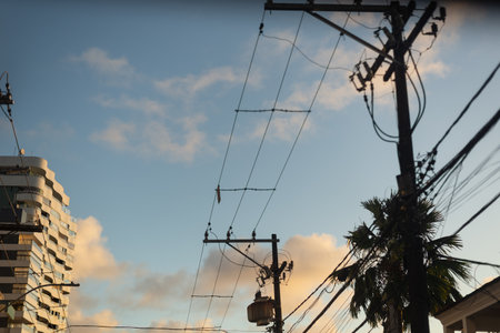 Electricity transmission poles against the dramatic late afternoon sky. Salvador city, Brazil.の写真素材