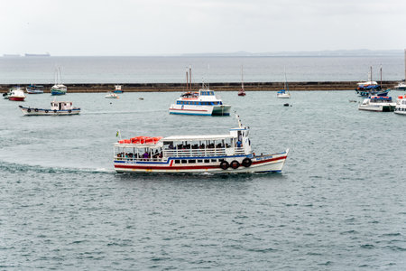 Salvador, Bahia, Brazil - October 08, 2023: Passenger and fishing boats sailing in the Bay of Todos os Santos in the city of Salvador, Bahia.のeditorial素材