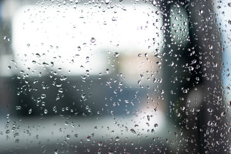 Abstract portrait of rain drops wetting a transparent glass. Abstract art.の写真素材