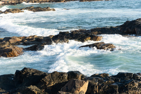 Sea waves breaking on the beach rocks. Preserved nature