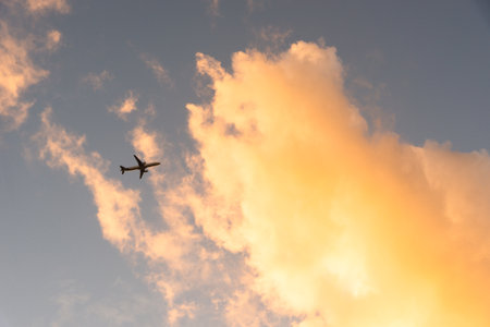 Airplane flying on blue sky with clouds. Technology on the rise