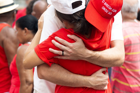 Salvador, Bahia, Brazil - December 04, 2023: Faithful embrace during a tribute to Santa Barbara in Pelourinho, city of Salvador, Bahia.のeditorial素材